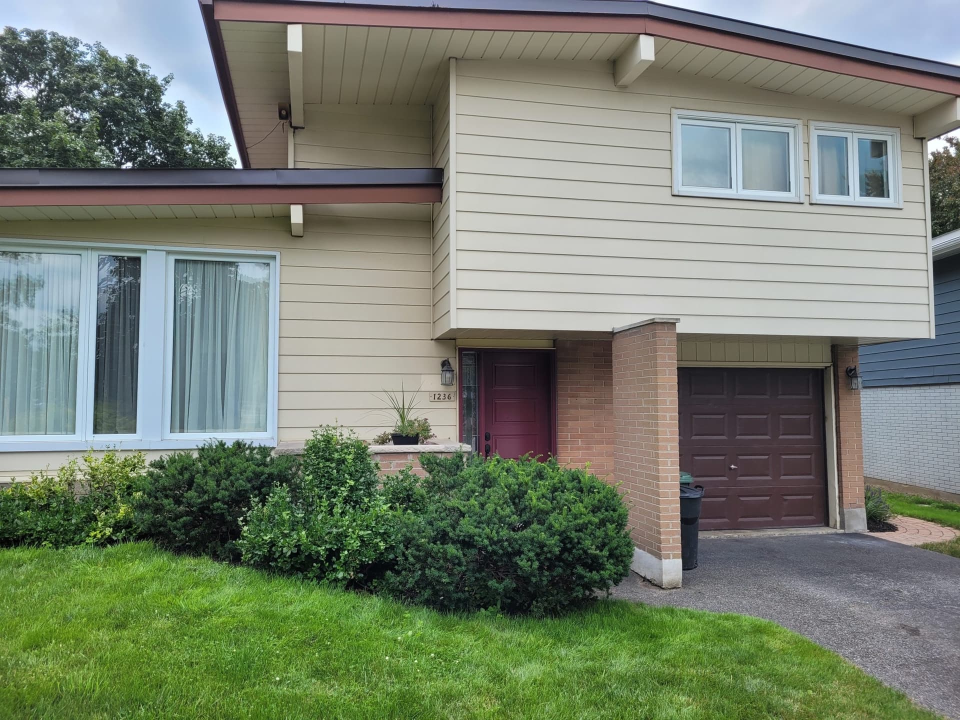 Yellow house exterior before painting - Ottawa home needing refresh