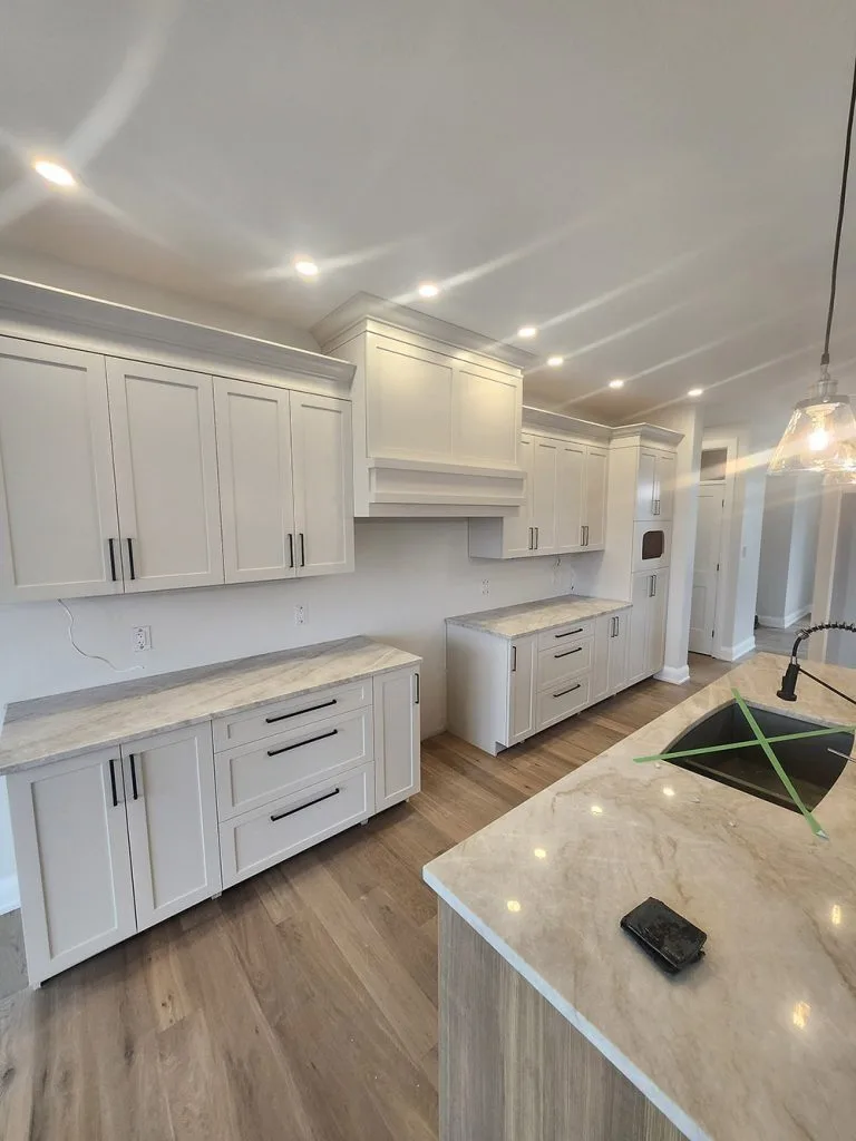 Ottawa kitchen after professional cabinet painting, white shaker cabinets with black hardware