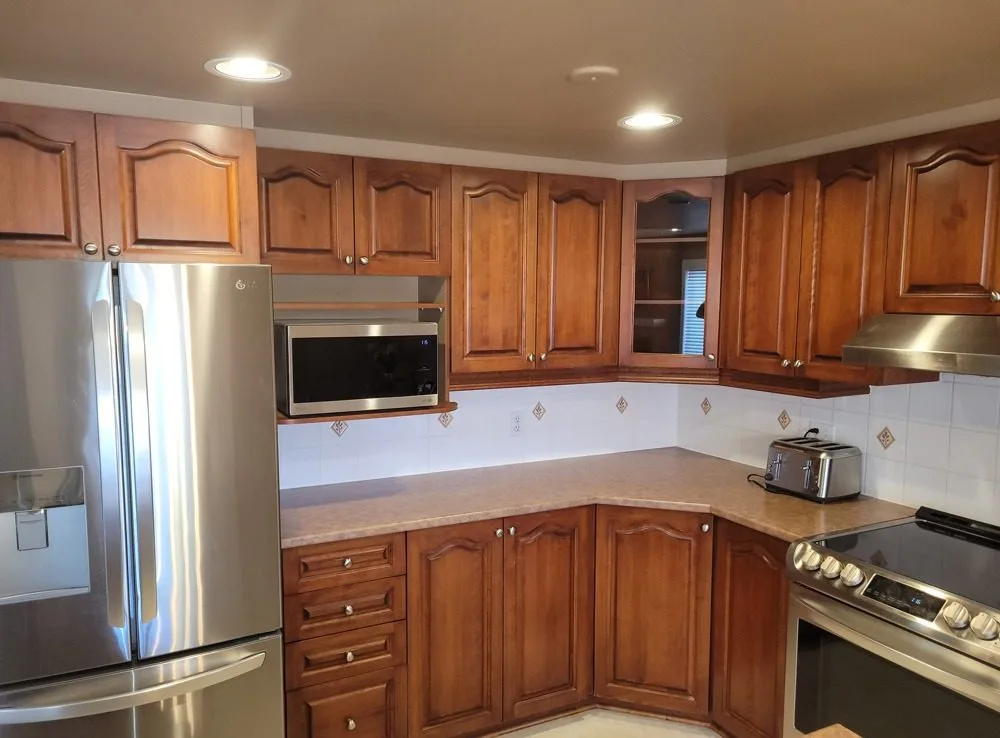 Kitchen before cabinet painting - dark wood cabinets